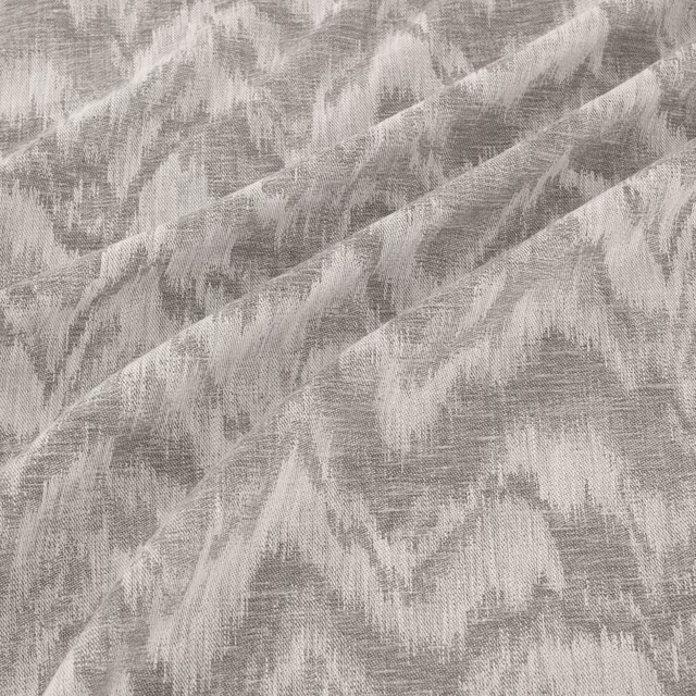 Cool steel-grey woven surface with pale, sweeping painterly brush marks