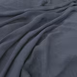 Draped cool denim blue-grey fabric showing a fine plain weave and soft folds