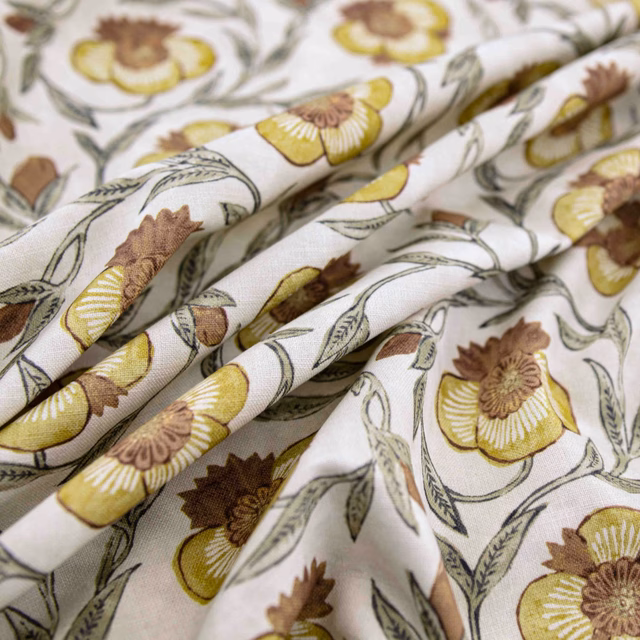 Ivory floral fabric with saffron blooms, brown centres and grey-green stems