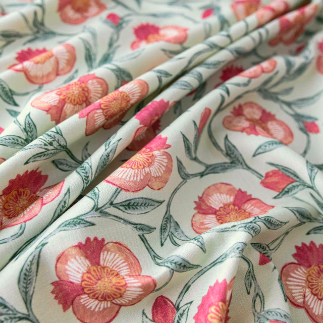 Cream floral fabric with coral and pink blooms, green trailing stems and soft folds