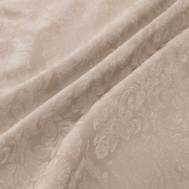 Warm ecru fabric with tonal damask motif and softly folded woven texture