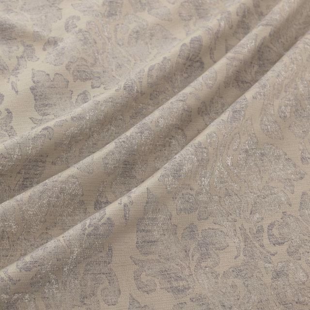Pale platinum-grey woven fabric with softly faded floral damask motifs and folded texture