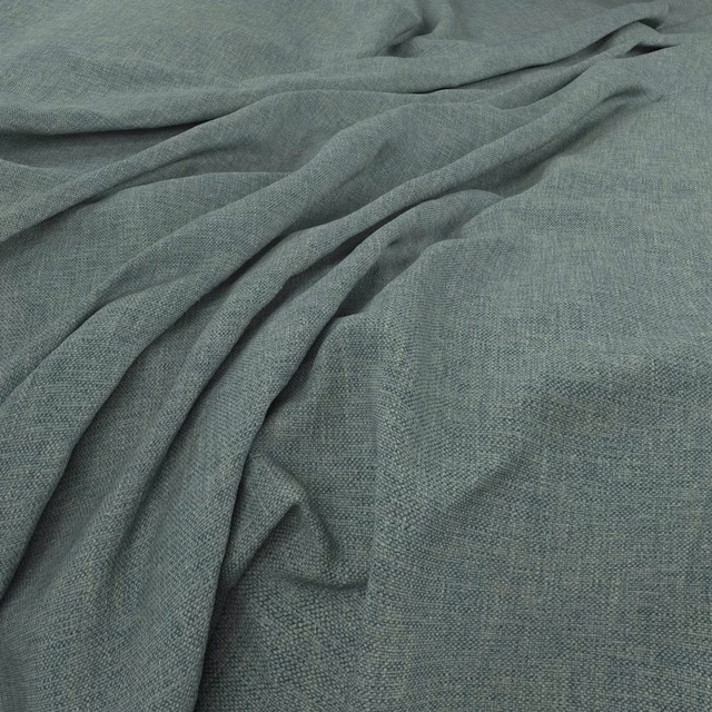 Muted kingfisher blue-green woven cloth with fine crosshatched texture in soft folds