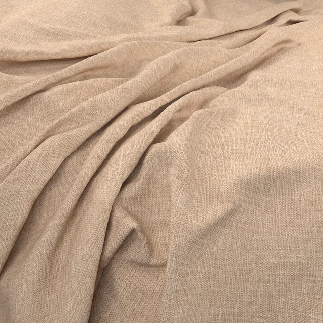 Warm sesame beige fabric with fine crosshatch weave gathered in soft flowing folds