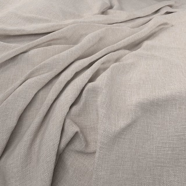Close-up of pale silver-grey woven fabric gathered into soft, fluid folds