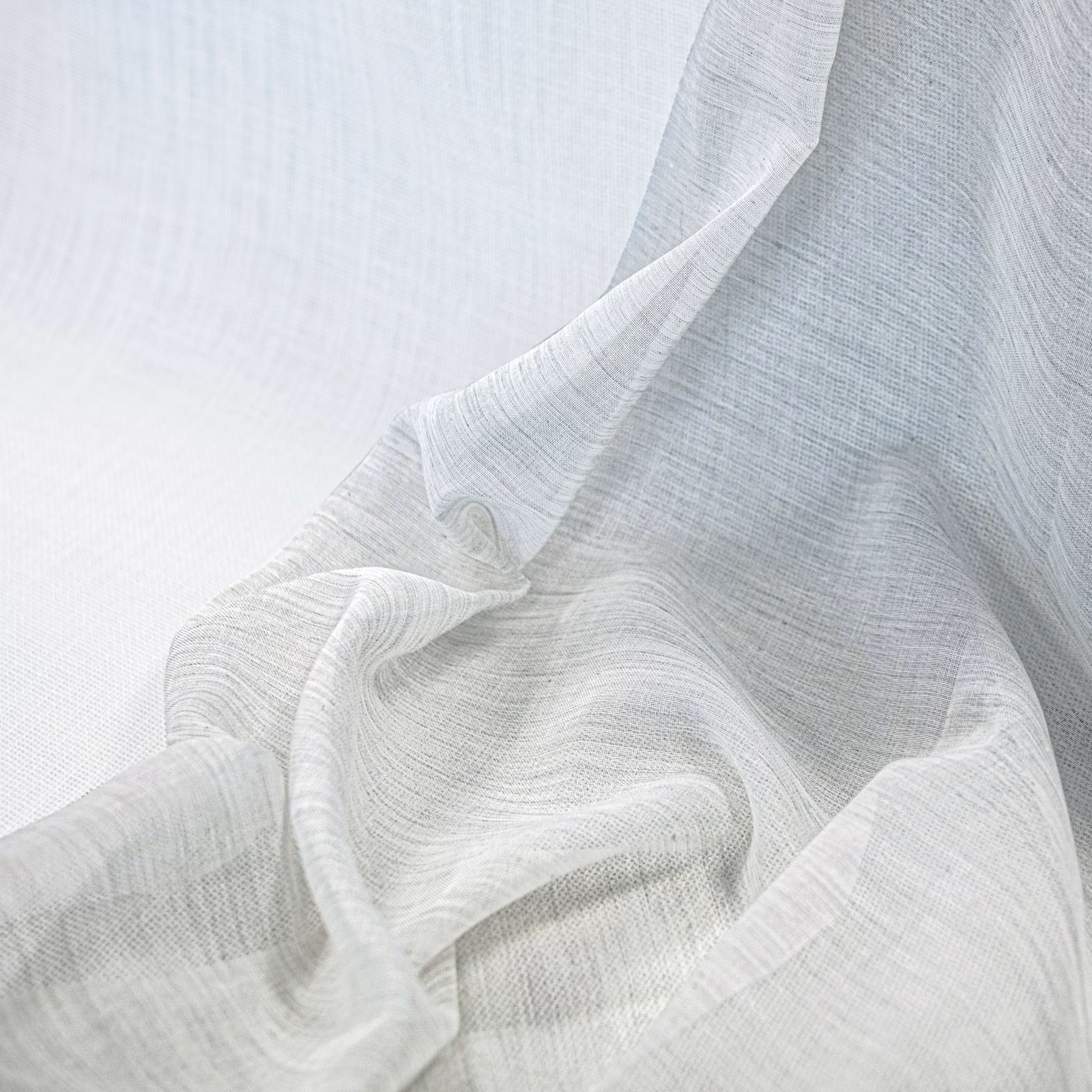 Soft ivory fine-weave fabric gathered in flowing, translucent folds