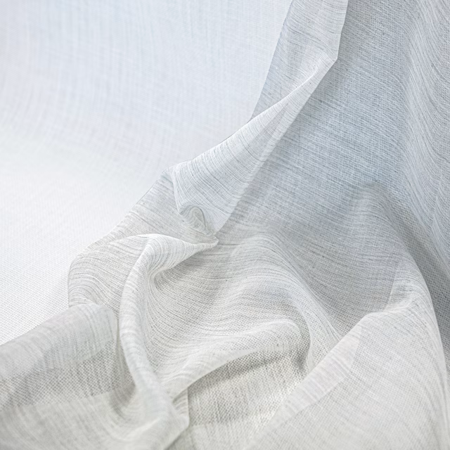 Soft ivory fine-weave fabric gathered in flowing, translucent folds