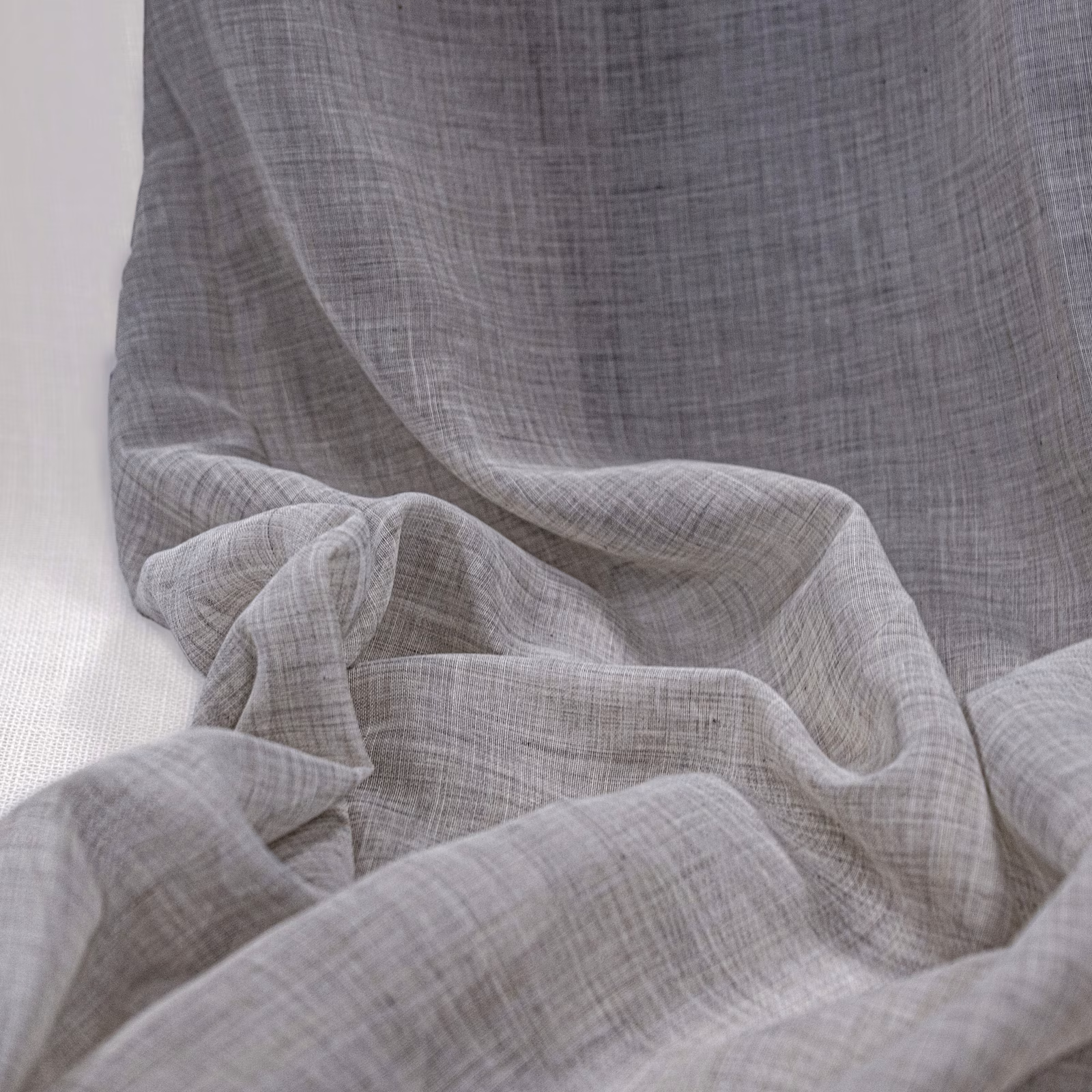 Warm grey-beige Lindos Natural fabric with a sheer crosshatched weave in soft folds