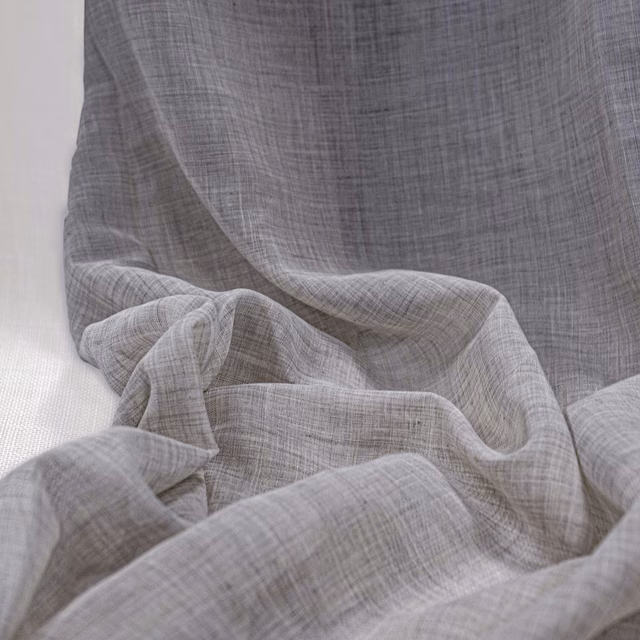 Warm grey-beige Lindos Natural fabric with a sheer crosshatched weave in soft folds