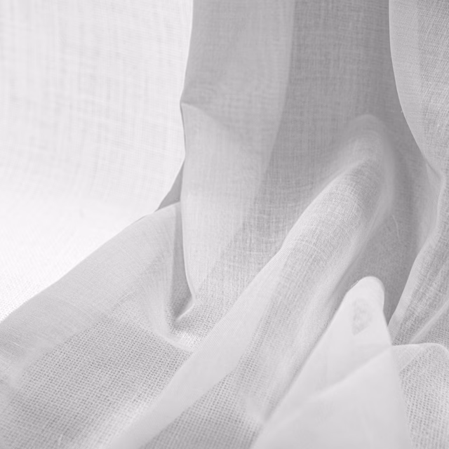Soft white open-weave fabric gathered into translucent-looking, fluid folds