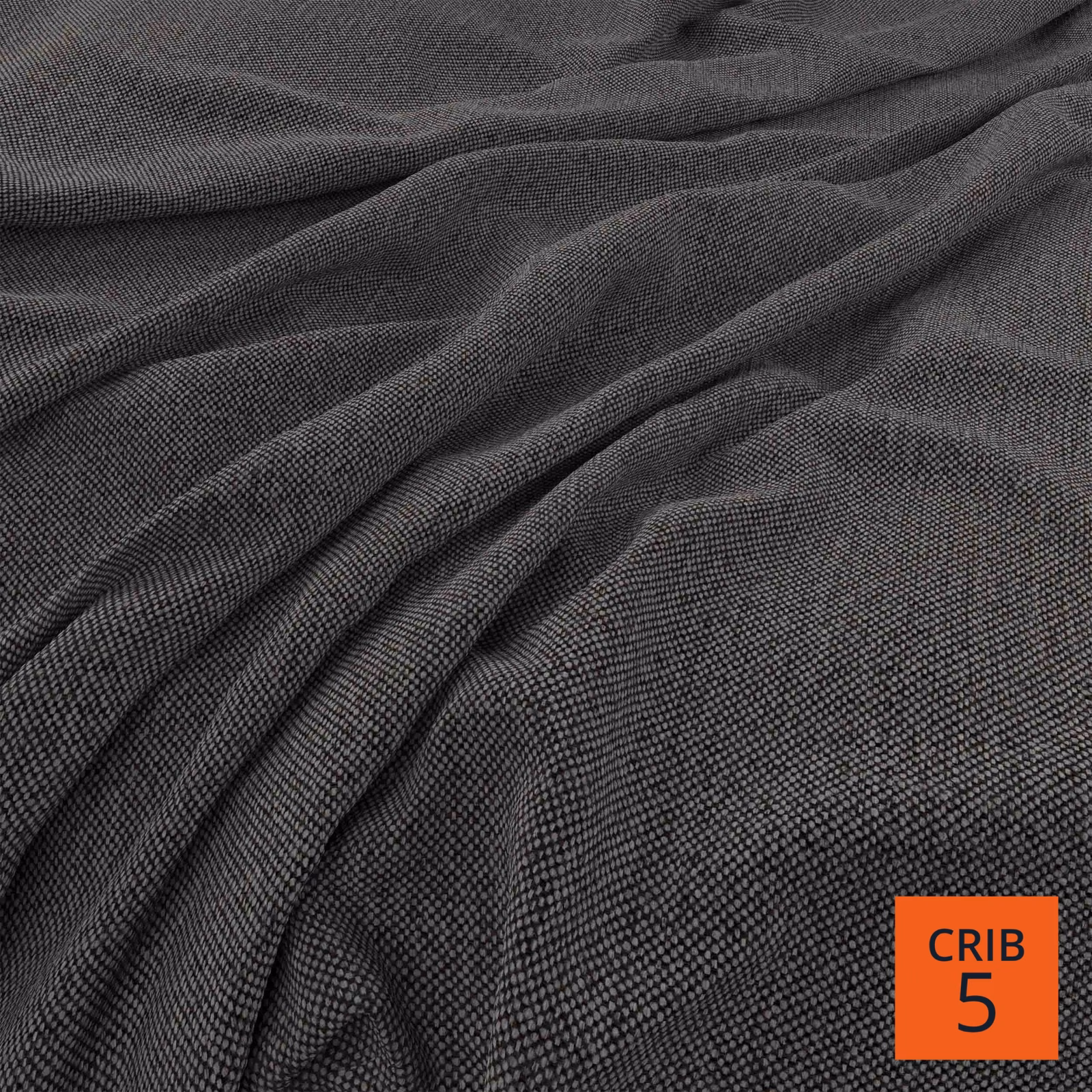 Deep charcoal fabric with fine linear weave gathered into softly shaded folds