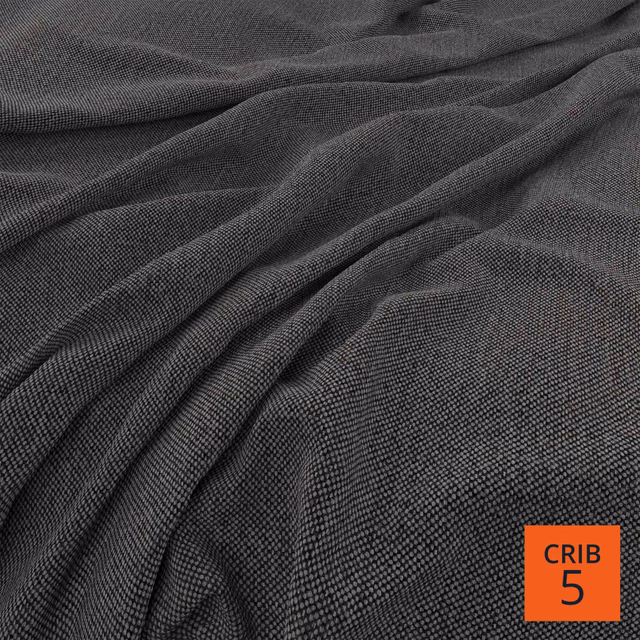 Deep charcoal fabric with fine linear weave gathered into softly shaded folds