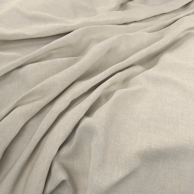 Pale celery-green plain-weave fabric gathered into soft, fluid folds