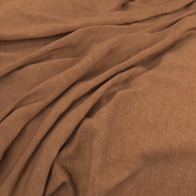 Warm henna-brown plain weave fabric gathered into softly shadowed folds