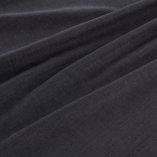 Anthracite grey fine weave fabric draped in softly folded, near-black ridges