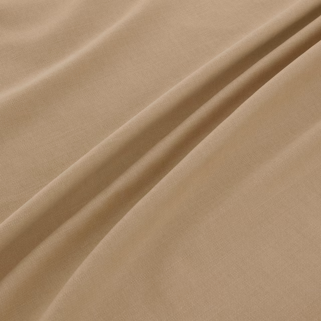 Warm oat-beige plain weave fabric folded to show fine texture and soft shadows