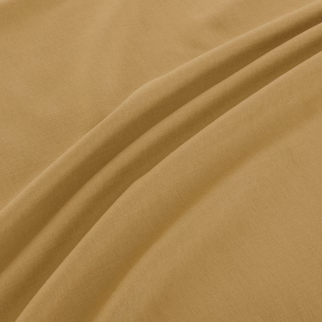 Warm camel woven fabric with fine texture and soft diagonal folds