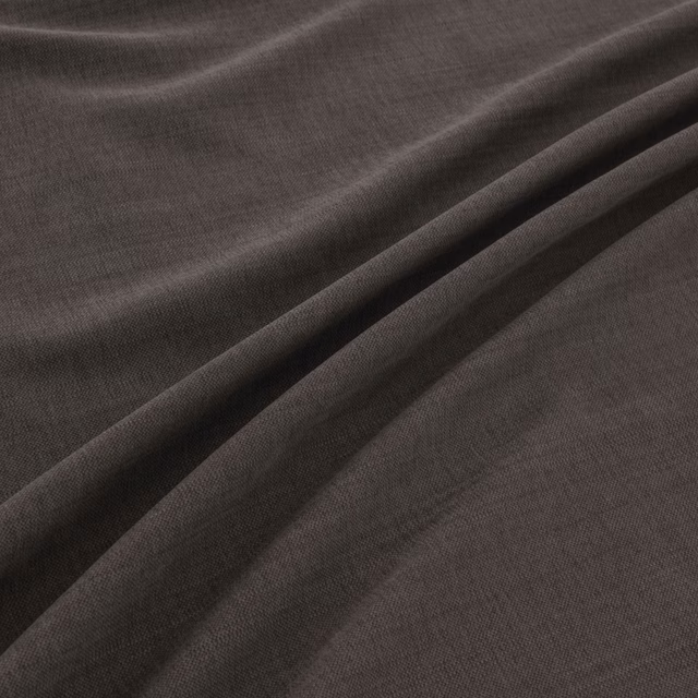 Deep charcoal-grey finely woven fabric draped into softly highlighted folds