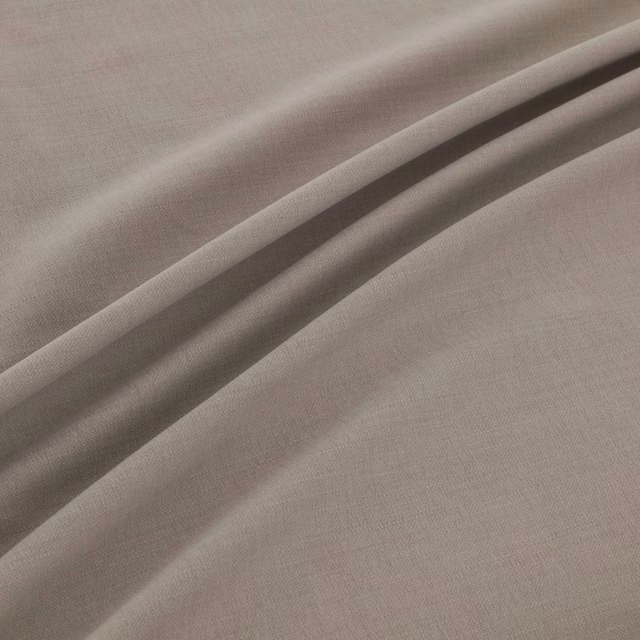 Soft warm grey fine-weave fabric draped into broad, shaded folds