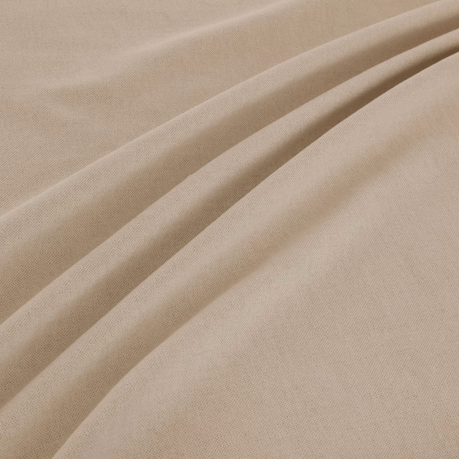 Warm natural-beige plain weave fabric falling in softly gathered folds