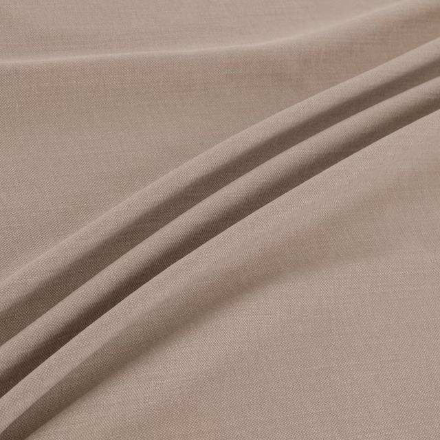 Warm sand-taupe fabric with a fine woven texture in soft diagonal folds