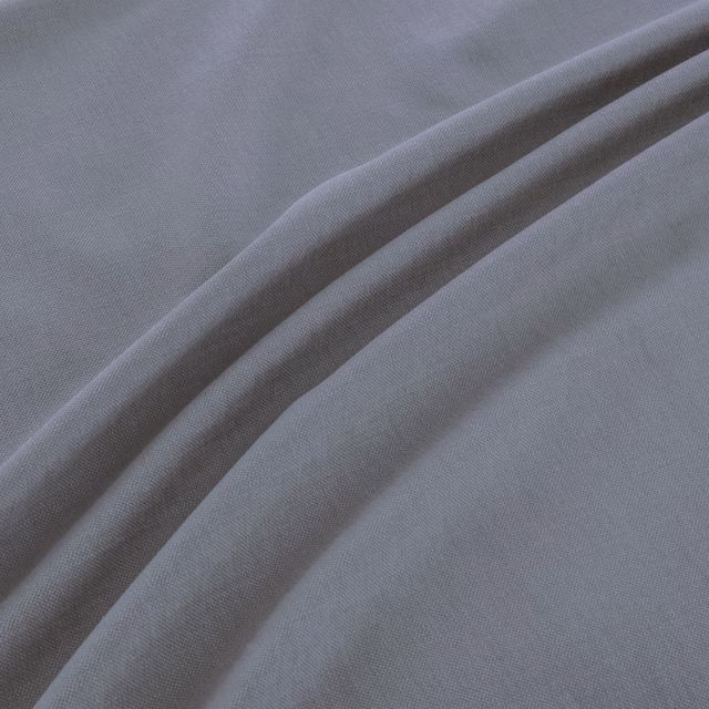 Folded muted blue-grey fabric showing a fine plain weave and soft fluid folds