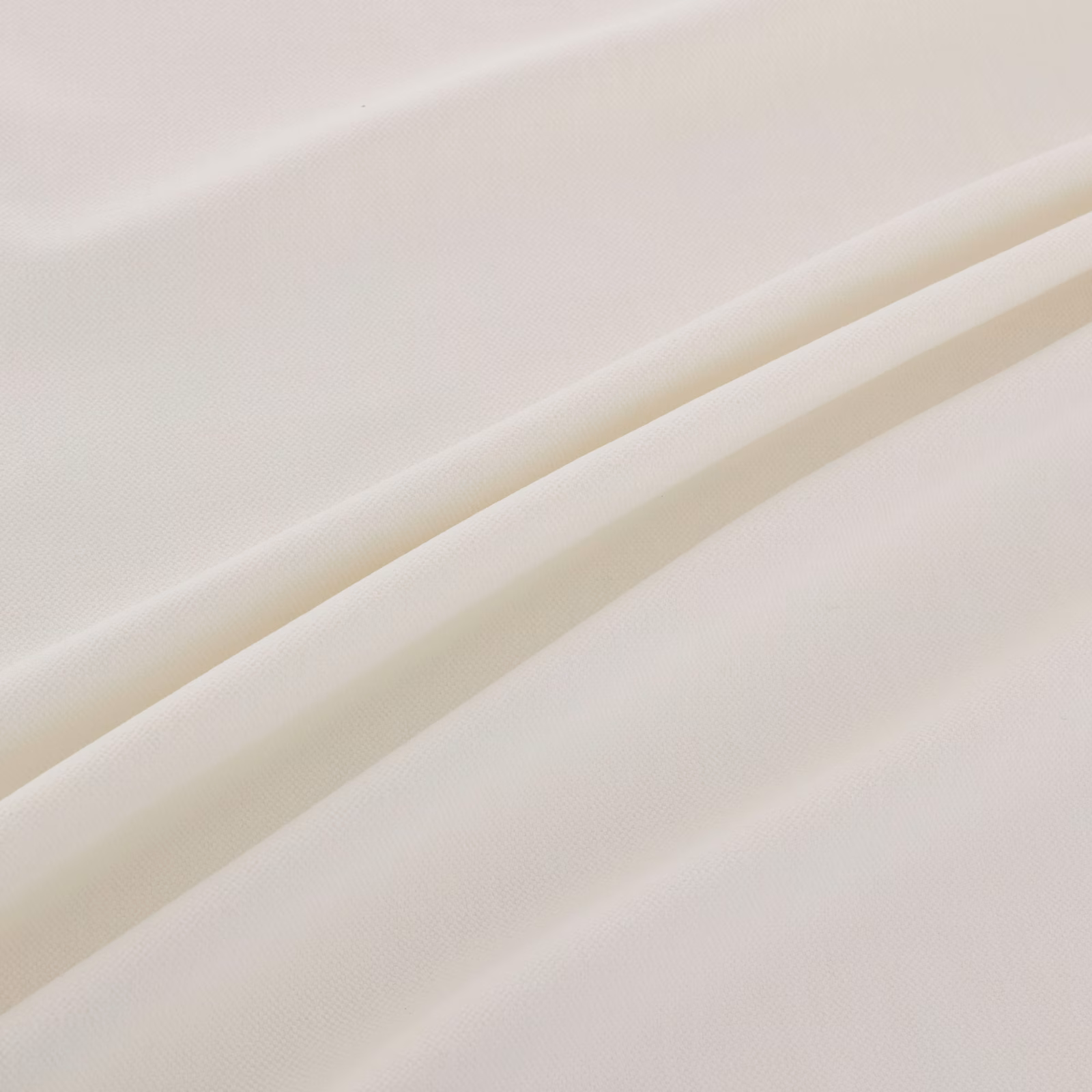 Soft ivory-white finely woven fabric falling into broad diagonal folds
