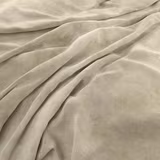 Warm almond beige velvet-like fabric draped in softly shaded folds