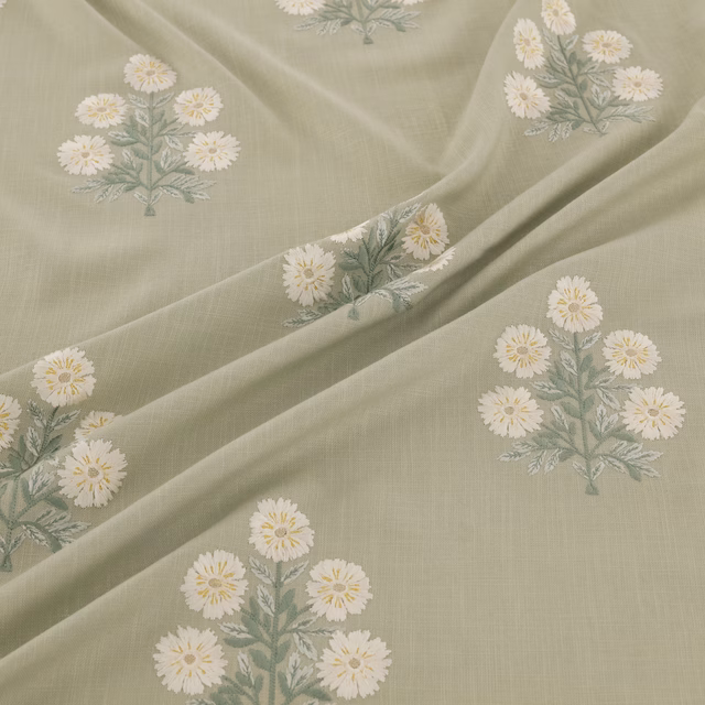 Pale eau-de-nil fabric with cream daisy bouquets and sage foliage in soft folds