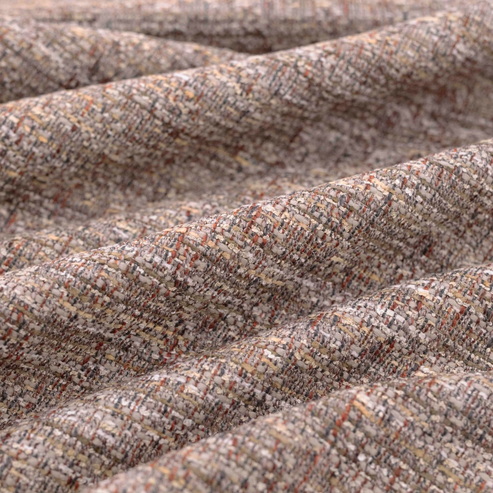 Mottled taupe woven fabric with rust, cream and charcoal flecks in close-up