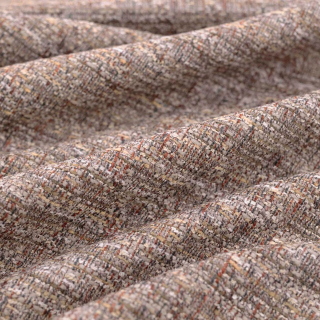Mottled taupe woven fabric with rust, cream and charcoal flecks in close-up