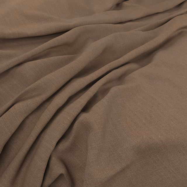 Warm taupe-brown plain-weave fabric arranged in soft, fluid folds