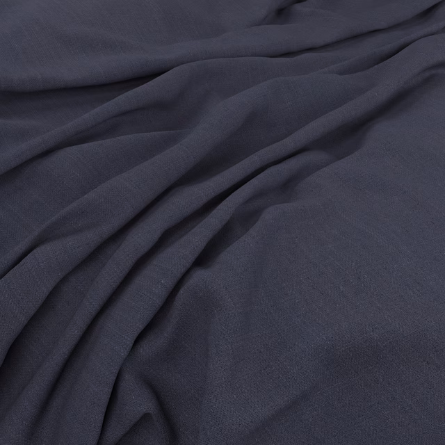 Deep blueberry blue plain-weave fabric shown in fluid overlapping folds