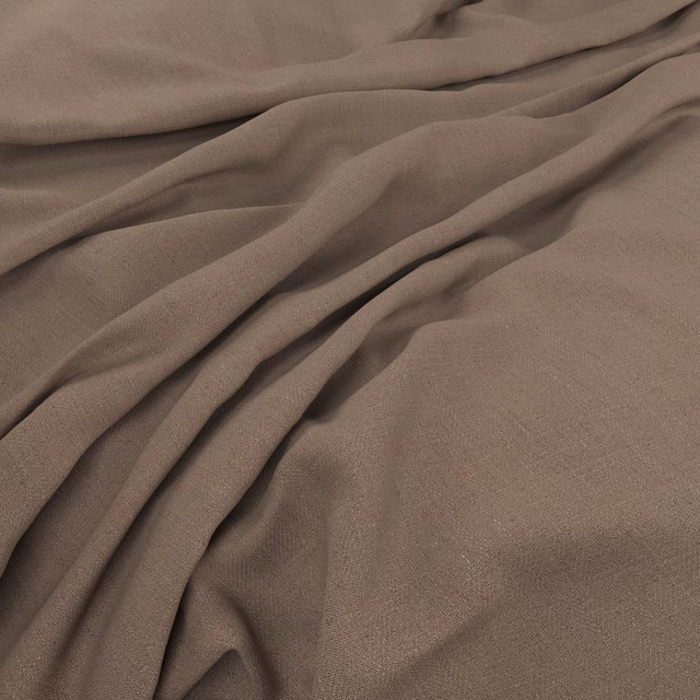 Warm mushroom-taupe woven fabric gathered into soft, shadowed folds