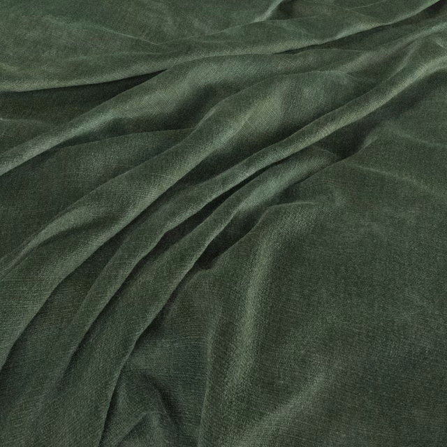 Deep forest-green woven fabric with fine texture and softly lustrous fluid folds
