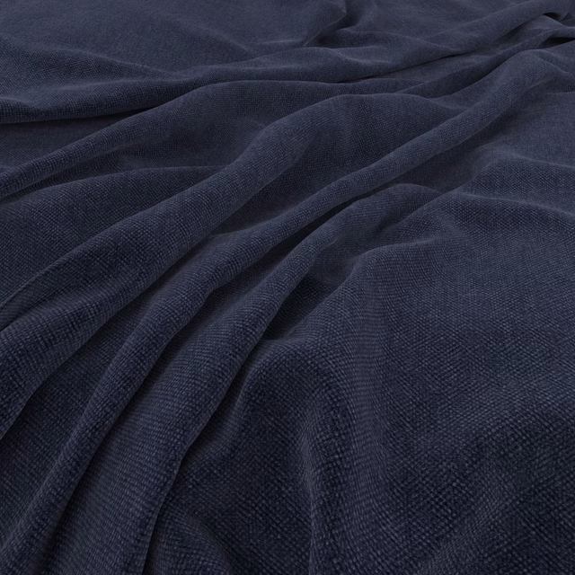 Deep denim blue fabric showing fine woven texture across softly gathered folds