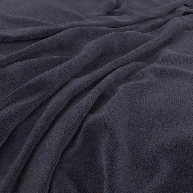 Deep indigo fabric with fine cross-textured weave falling into soft folds