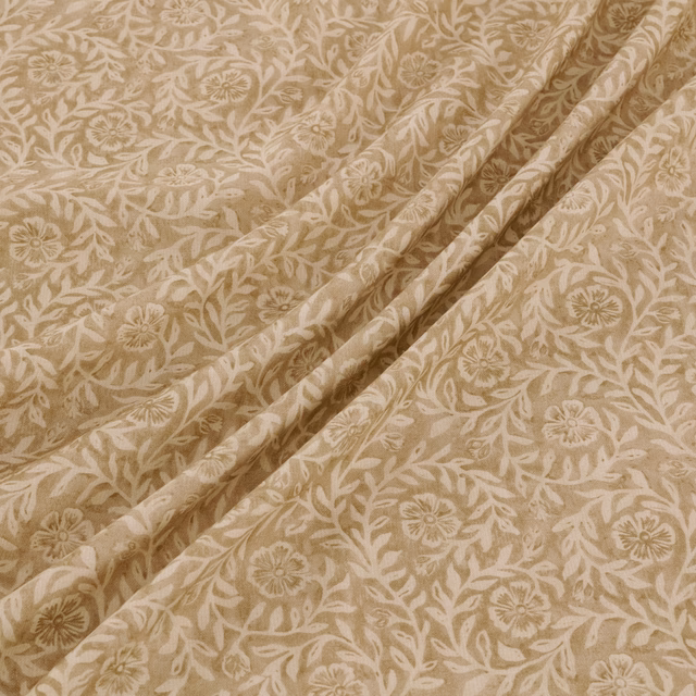 Warm dune-beige fabric with ivory scrolling flowers, leaves and softly textured woven surface