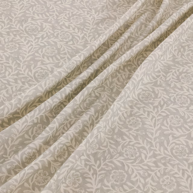 Warm gull-grey fabric with ivory trailing florals gathered into soft folds