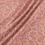 Dusty rose floral fabric with cream vines and folded botanical drape