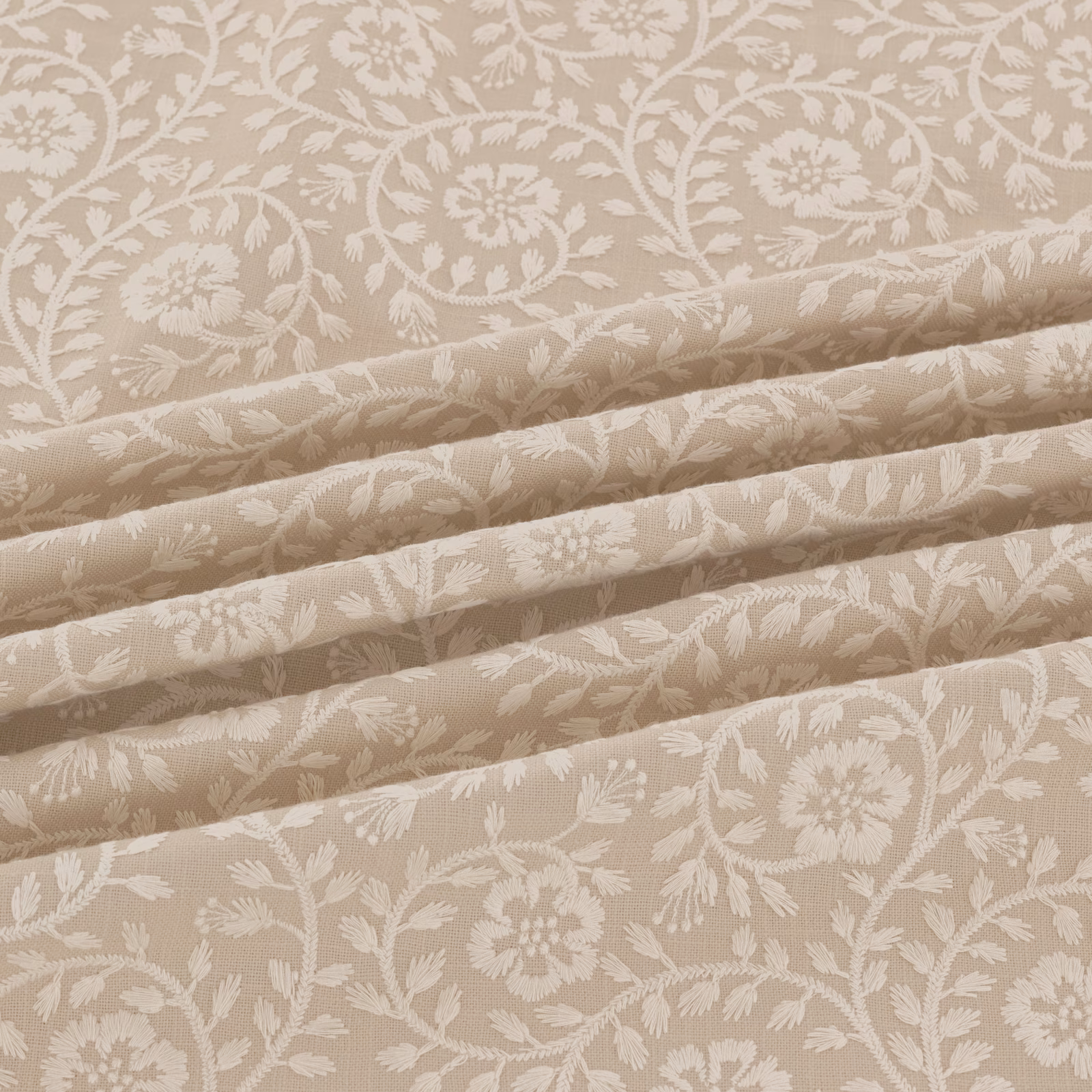 Warm taupe-beige woven fabric with cream floral sprays and scrolling stems in folded view