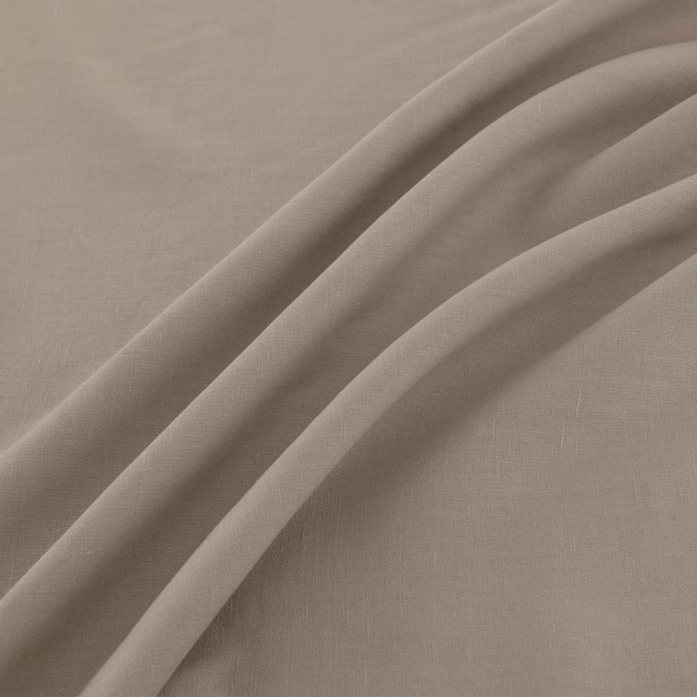 Warm taupe plain-weave textile draped in broad, softly shadowed folds