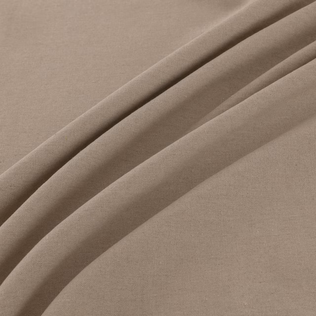 Warm natural taupe plain weave fabric draped into soft, fluid folds