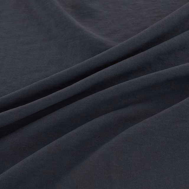 Deep blue-charcoal fine weave falling into soft sweeping folds