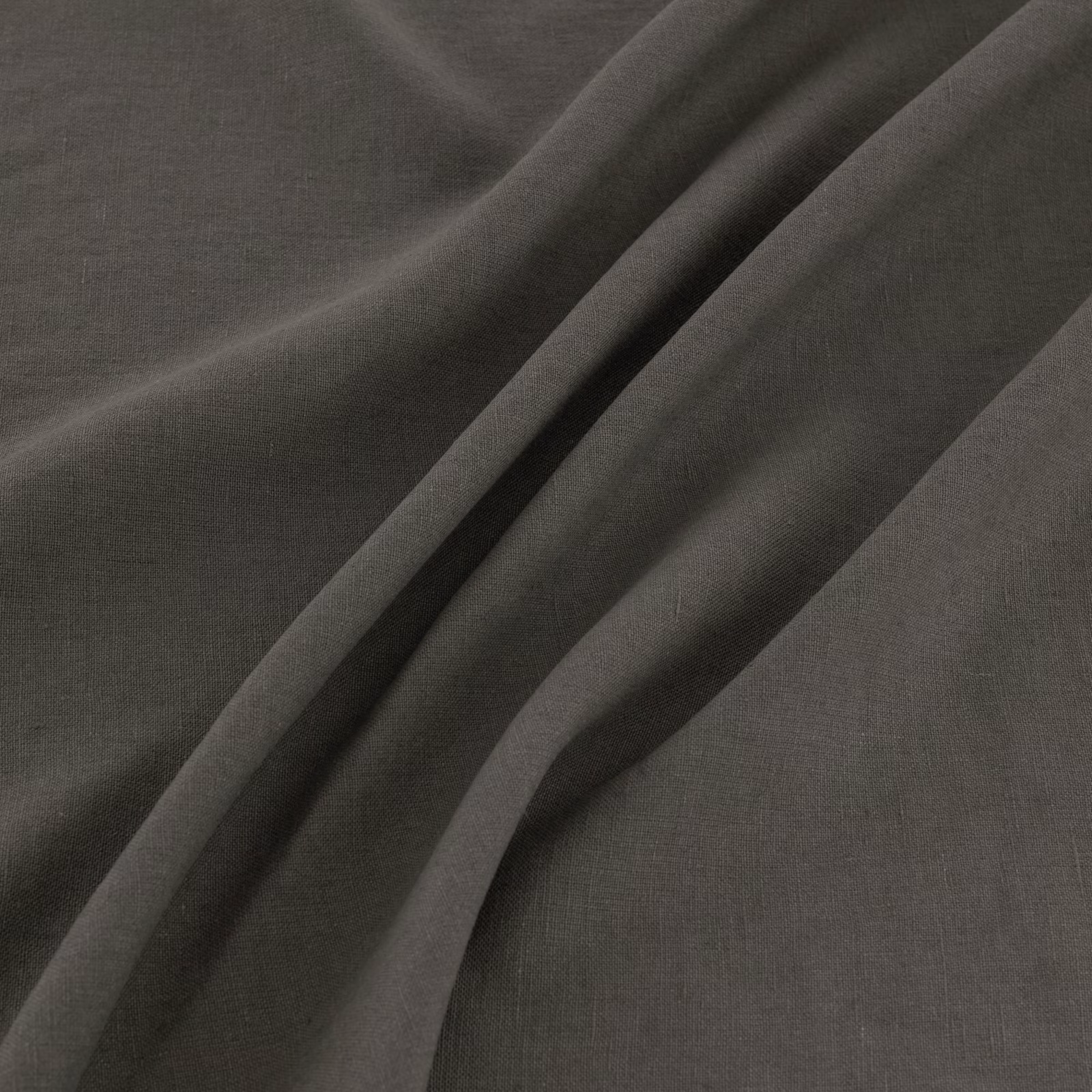 Charcoal-grey plain weave showing fine texture and deep diagonal folds