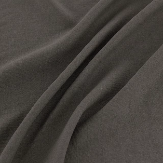 Charcoal-grey plain weave showing fine texture and deep diagonal folds