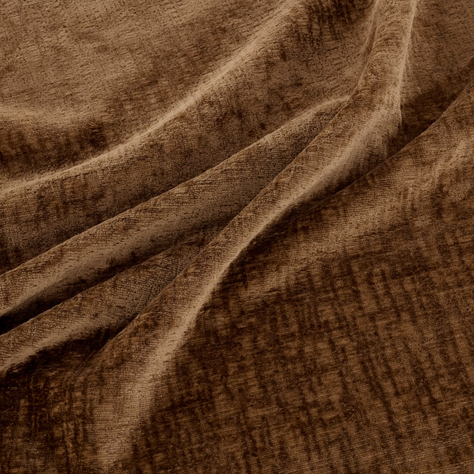Warm amber-brown fabric with brushed crosshatch texture gathered into soft folds