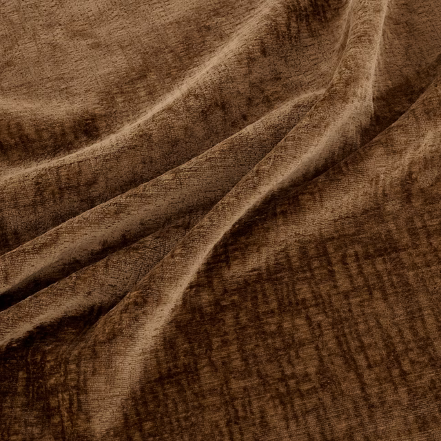 Warm amber-brown fabric with brushed crosshatch texture gathered into soft folds
