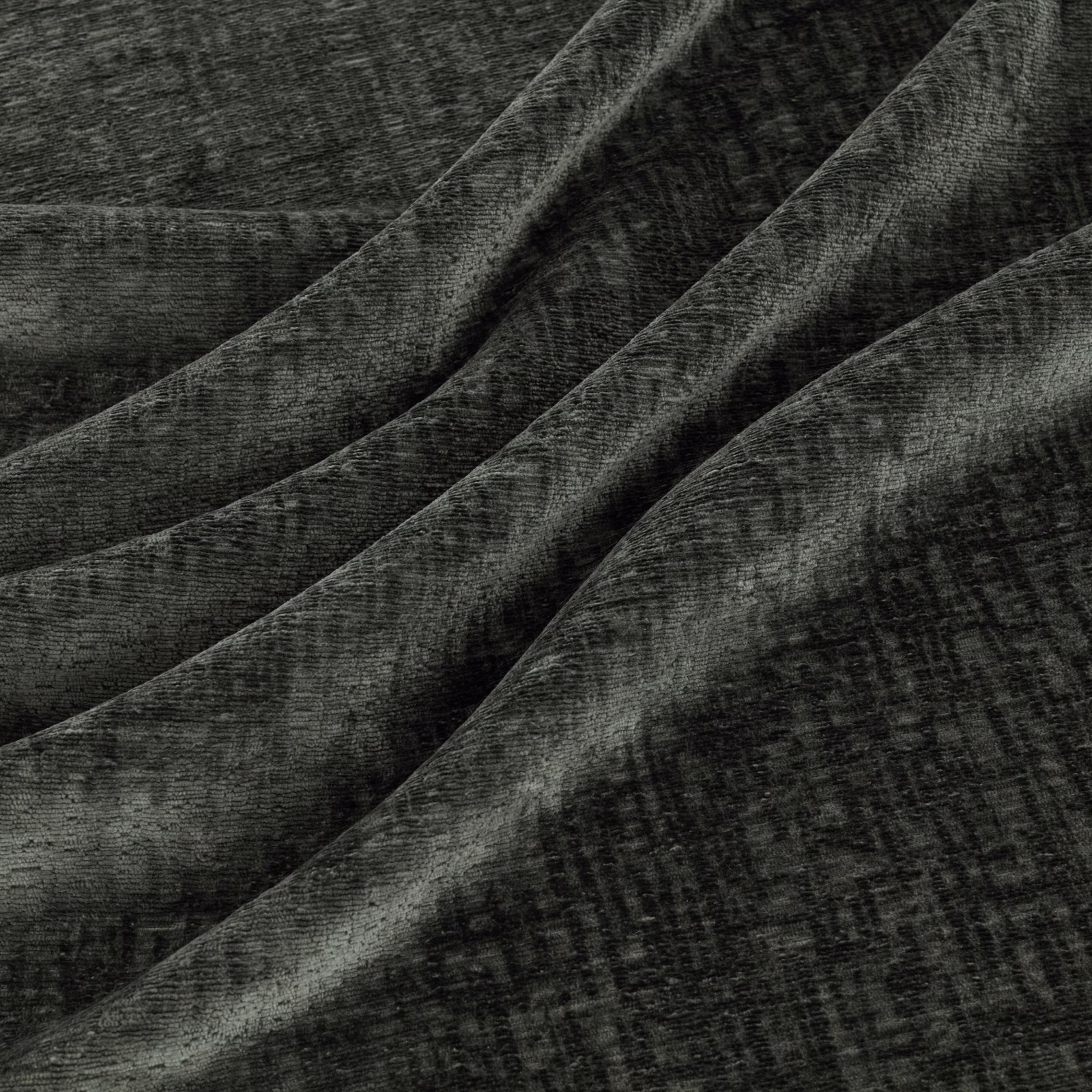 Deep graphite-grey textured fabric with mottled crosshatching folded into soft diagonal ridges