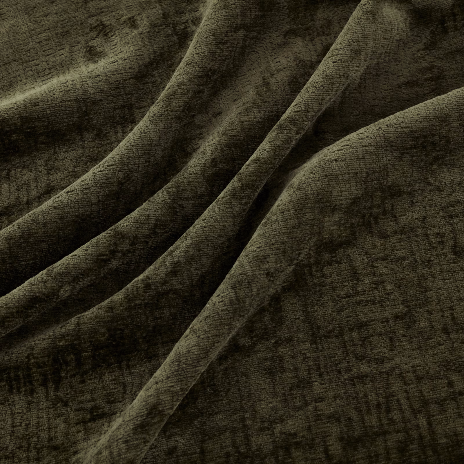 Deep hunter olive fabric with plush mottled texture folded into soft ridges